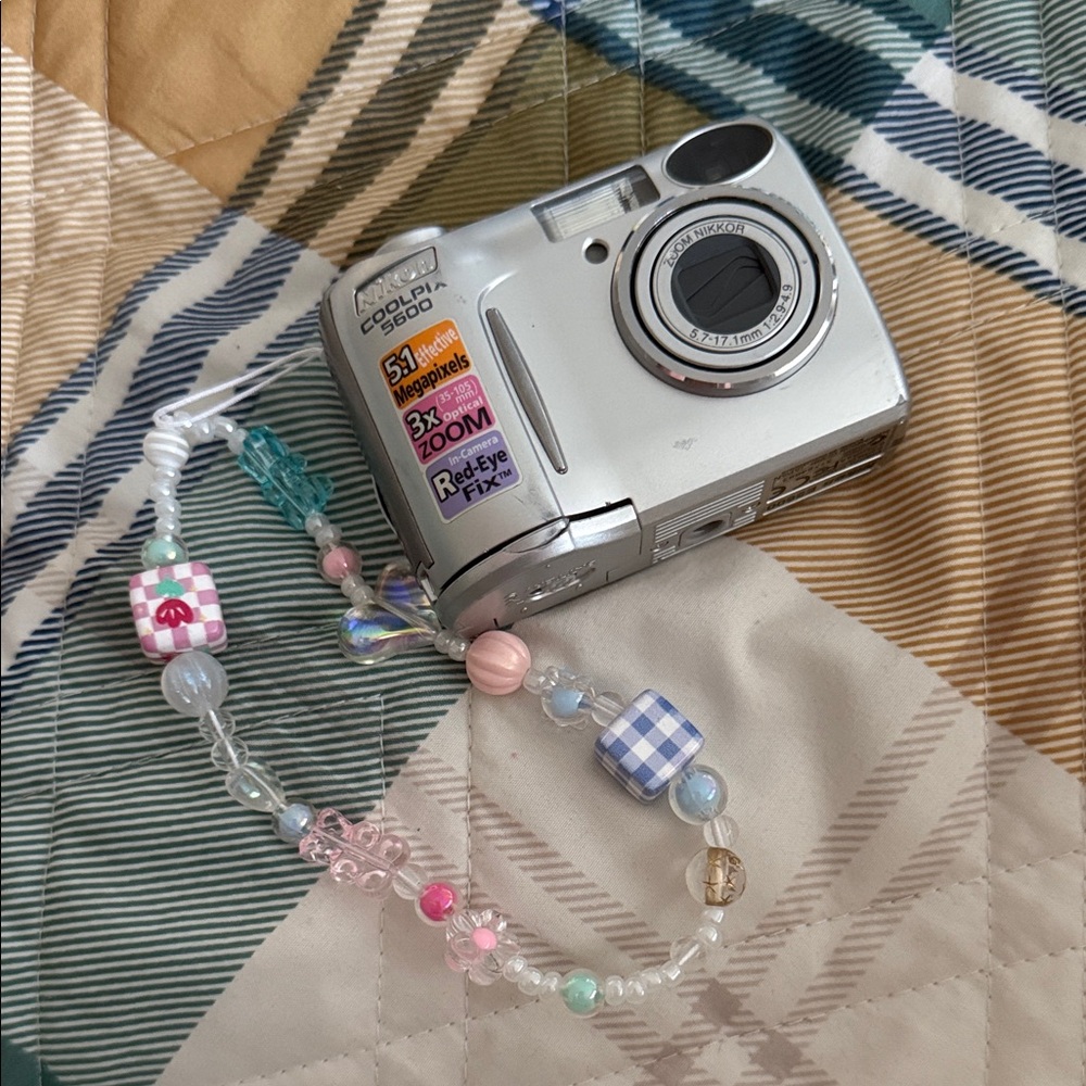 Silver Nikon digital camera [WORKS]